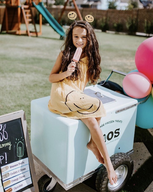 happy birthday girl enjoying a frios pop with a frios pop cart