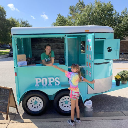 frios pops trailer in austin texas with happy customer