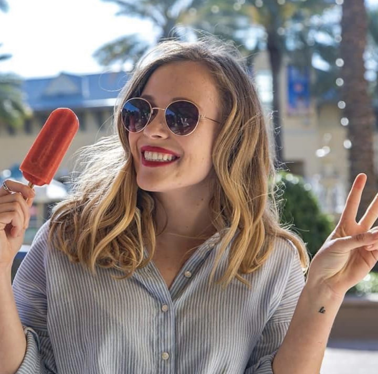 happy frios customer smiling holding a frios